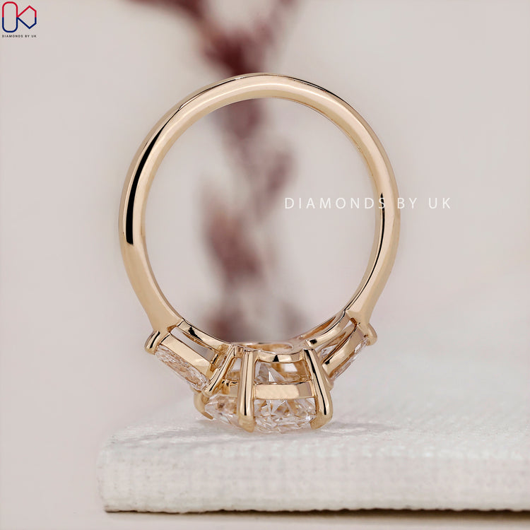 Handmade ring featuring a stunning 3 stone diamond engagement ring with an oval diamond ring centre.
