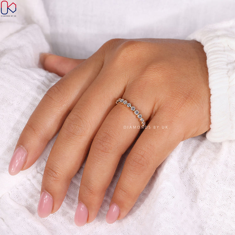 Diamond half eternity band set in yellow gold for a graceful finish.

