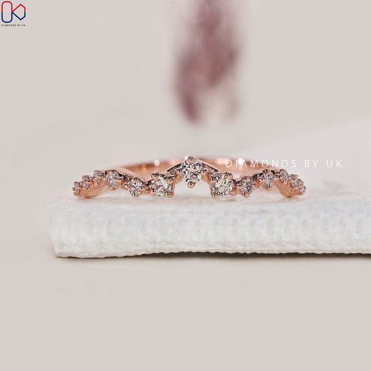 Prong set wedding band with brilliant round cut diamonds.
