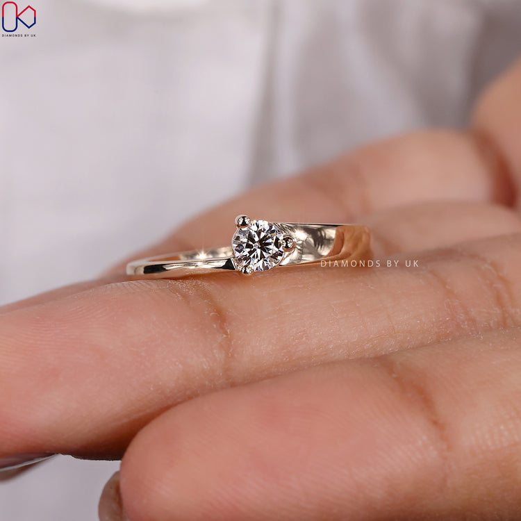 Handmade solitaire engagement ring with a round diamond.
