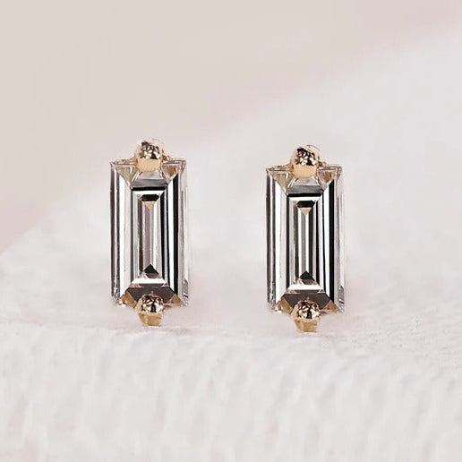 Baguette cut diamond earrings in a stud style.