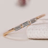 Baguette cut diamond wedding band with three stones.
