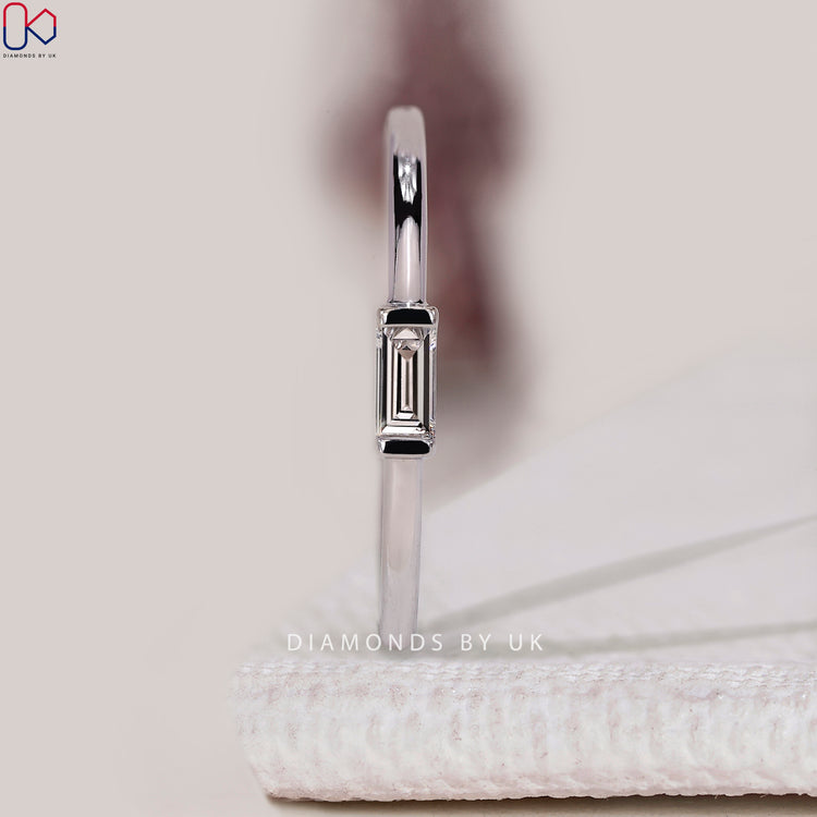 Baguette diamond wedding band with solitaire style.

