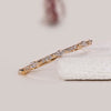 Round diamond wedding band crafted in yellow gold for stacking or wearing solo.
