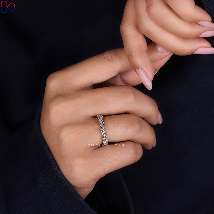 Yellow gold wedding band designed with marquise and round diamonds placed evenly.

