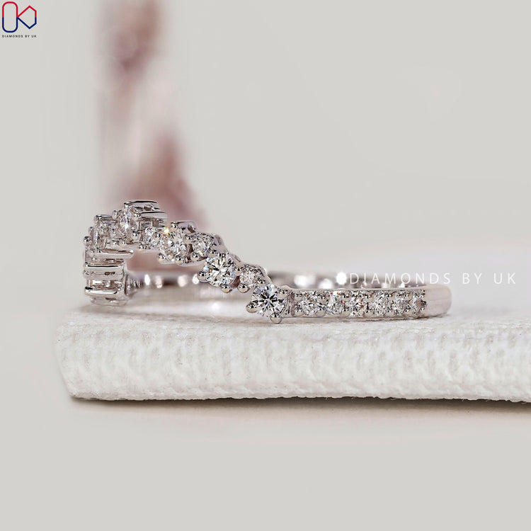 Round cut lab grown diamond band with curved design.