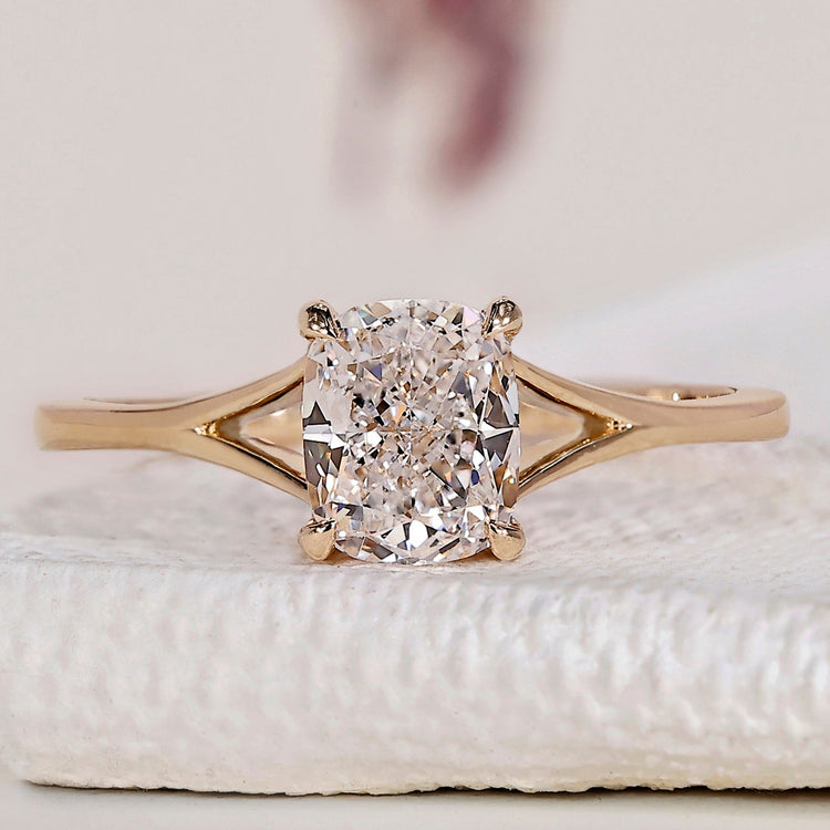Cushion cut solitaire ring with split shank design.