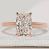 Cushion cut solitaire ring with cathedral setting.