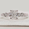 Cushion cut ring with round side stones, five stone.
