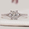 Cushion cut ring with split shank and claw prongs.