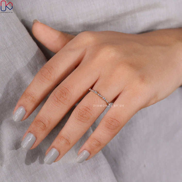 Half eternity wedding band with alternating marquise and round diamonds in yellow gold.
