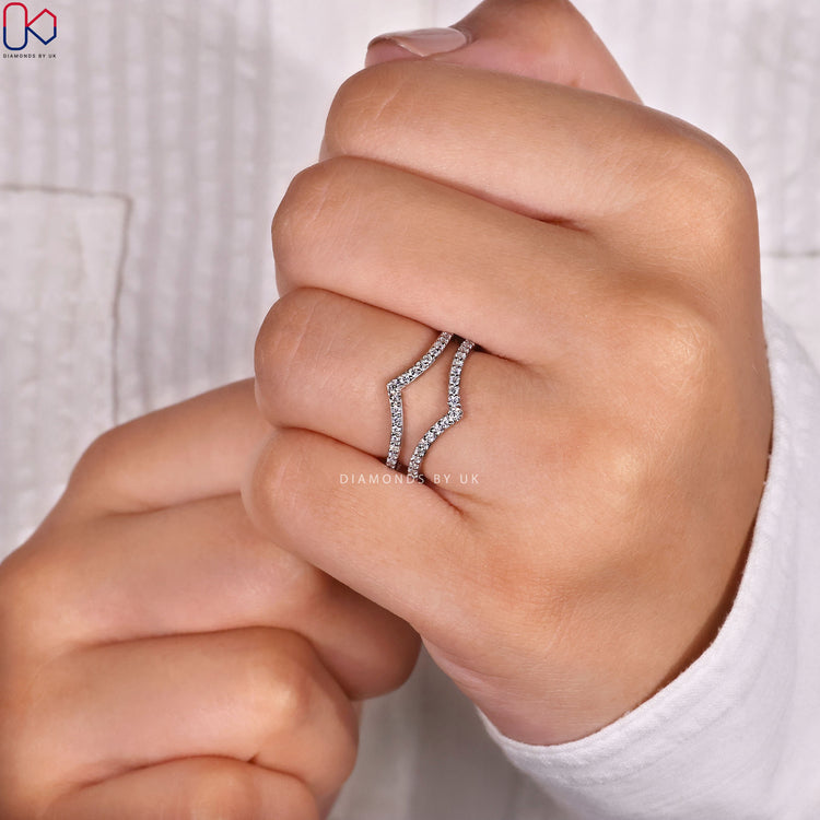 Unique wedding band featuring a wrap enhancer shape for a layered bridal look.

