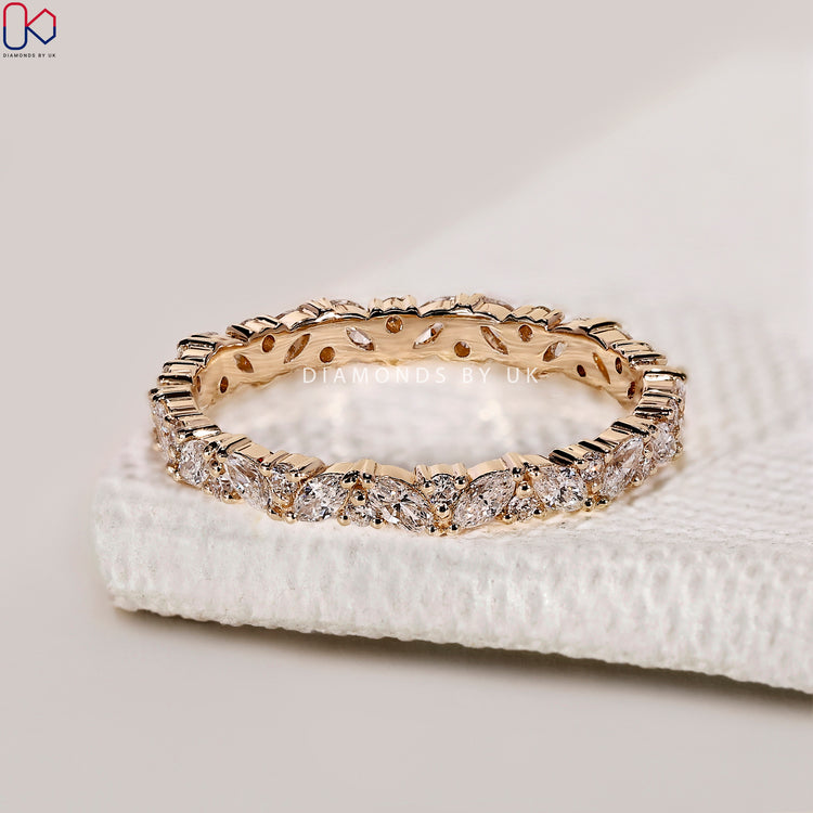 Alternating marquise diamond wedding band set in a seamless full eternity design.
