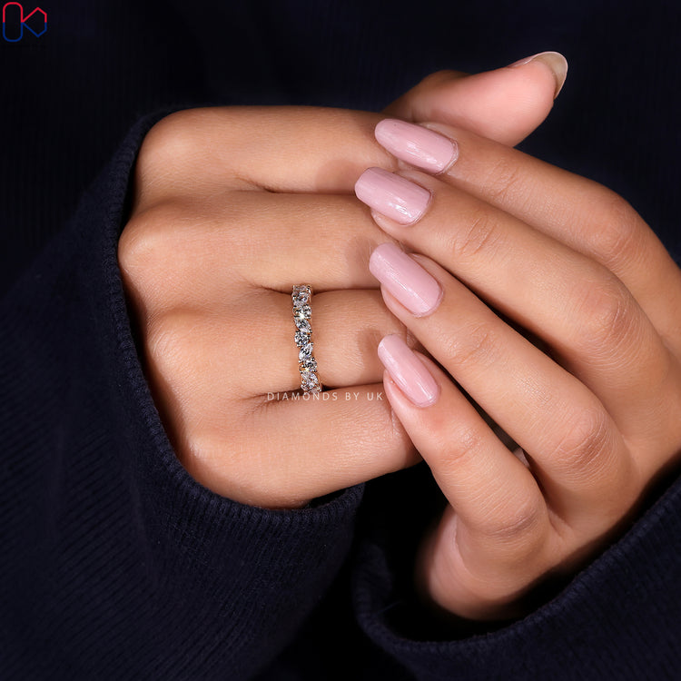 Prong set eternity band with lab grown alternating diamond shapes in handmade quality.
