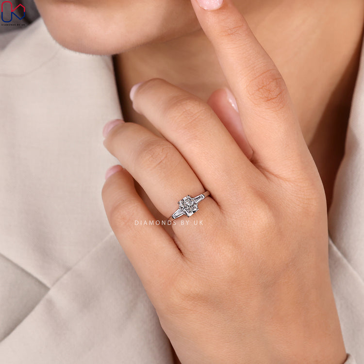 Pear three stone ring with round cut side stones.