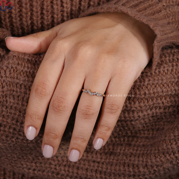 Yellow gold wedding band featuring round diamonds and subtle handmade curves.
