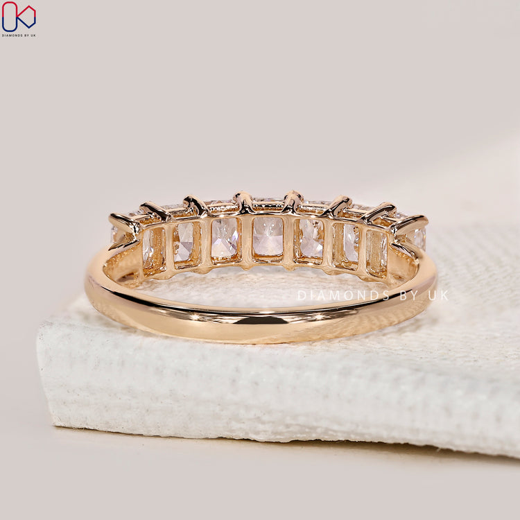 Half eternity wedding band designed for stacking or wearing solo with radiant cuts.
