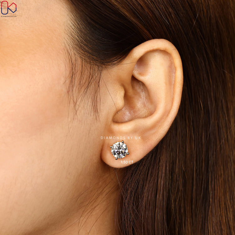 Round cut diamond earrings with screw back closure.  