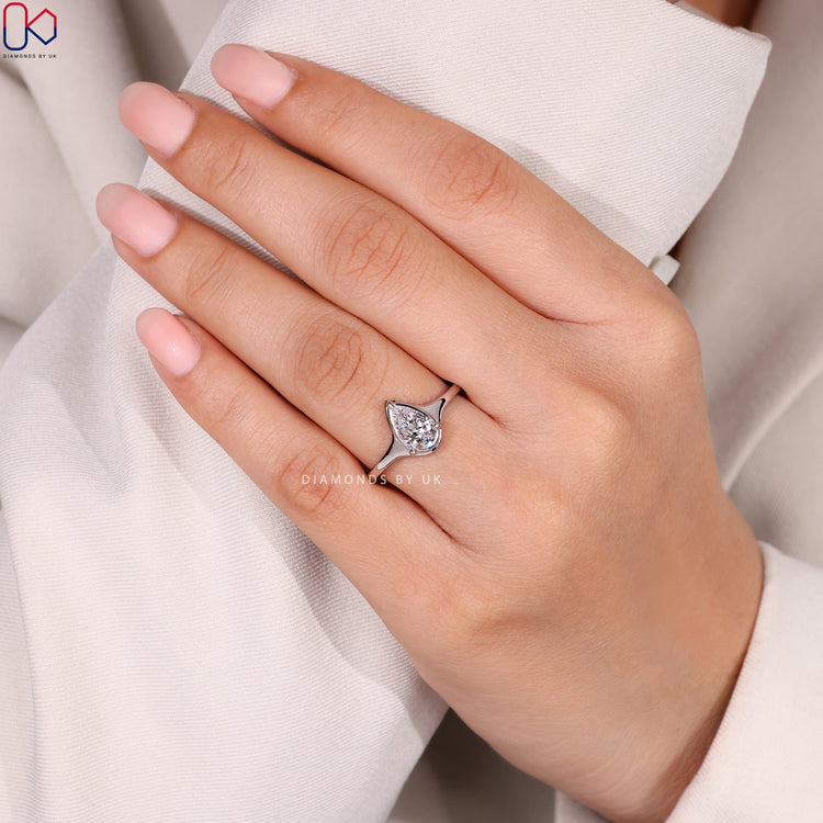 Pear cut solitaire ring with secure bezel setting.