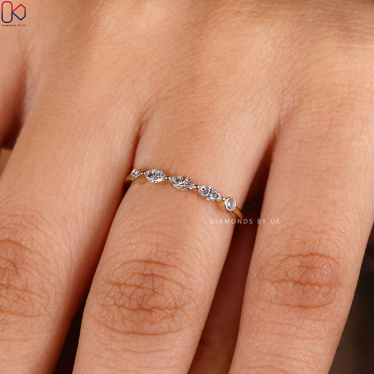 Lab grown diamond band with marquise and round stones.
