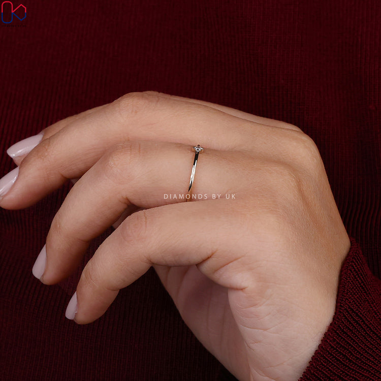 Round cut lab grown diamond band with compass prongs.
