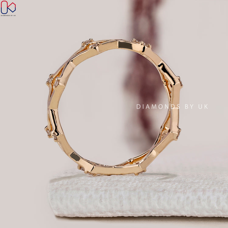 Handmade round cut diamond band with crossover design.