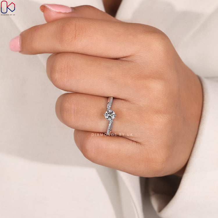 Four compass prong round cut diamond ring.