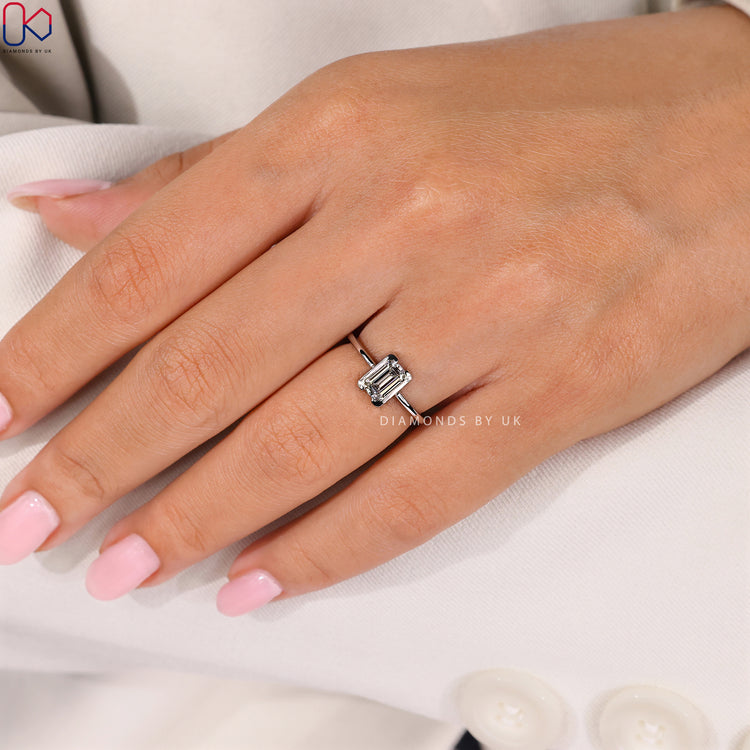 Lab grown emerald cut solitaire ring with bezel.
