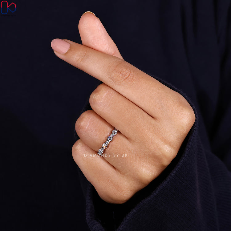 Round cut wedding band with prong setting by Diamondsbyuk.