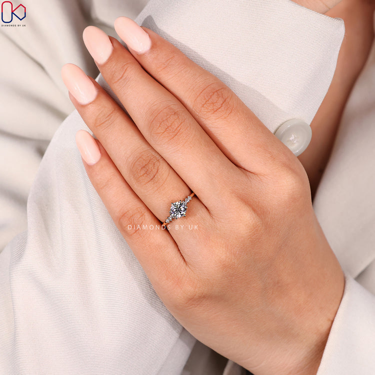 Seven stone round cut ring with side diamonds.