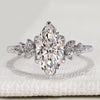 Marquise cut engagement ring with round side stones.
