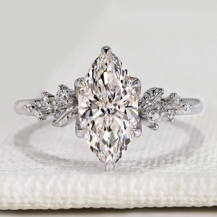 Marquise cut engagement ring with round side stones.
