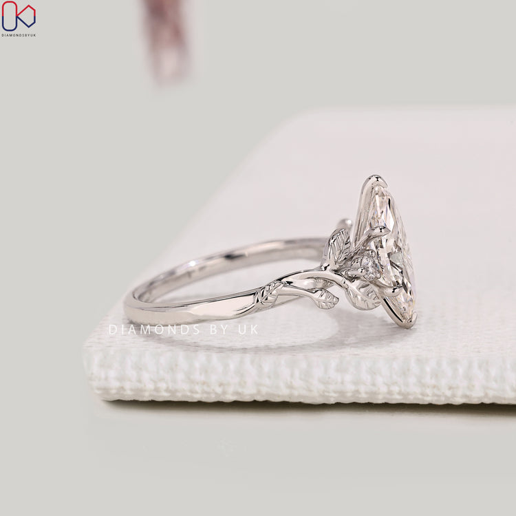 Lab grown marquise diamond ring with six claw prongs.

