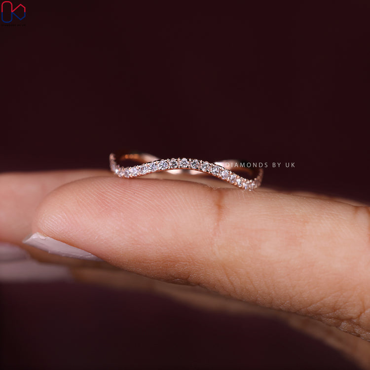 Lab grown diamond band with round stones and wave style.
