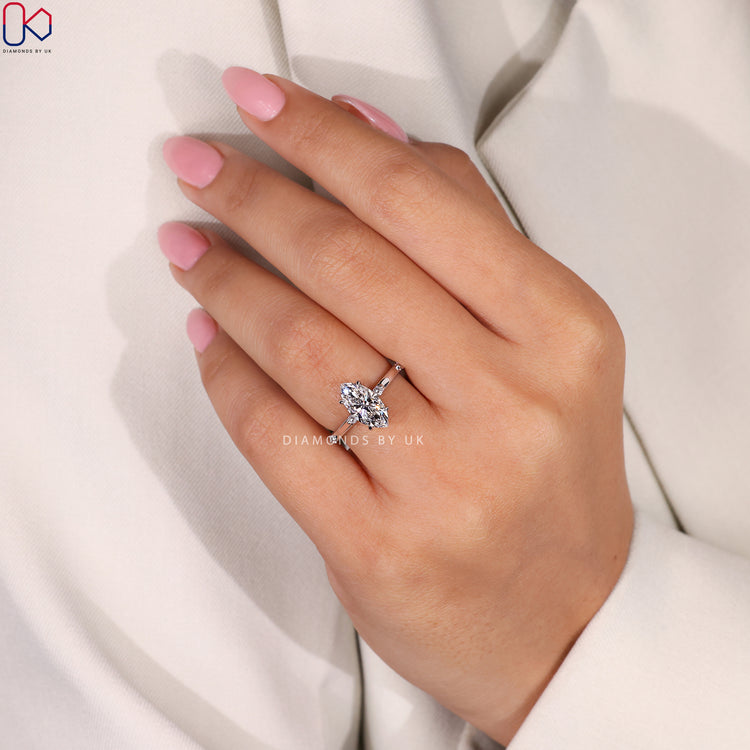 Lab-grown marquise diamond ring with round diamond halo.

