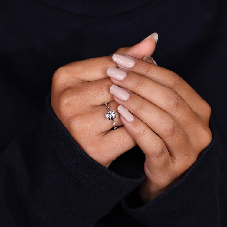 Round diamond ring with distance pavé design.