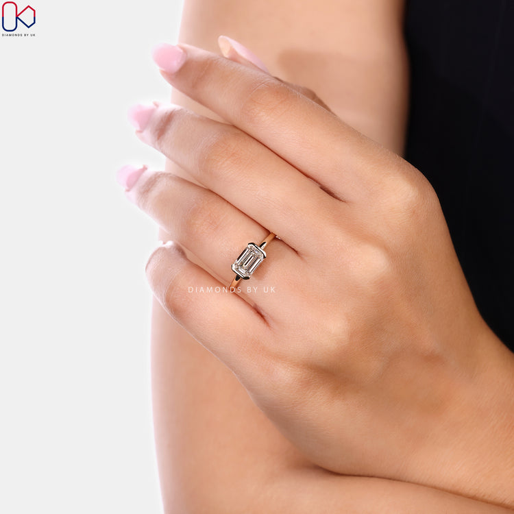 Emerald cut lab grown diamond ring with half bezel
