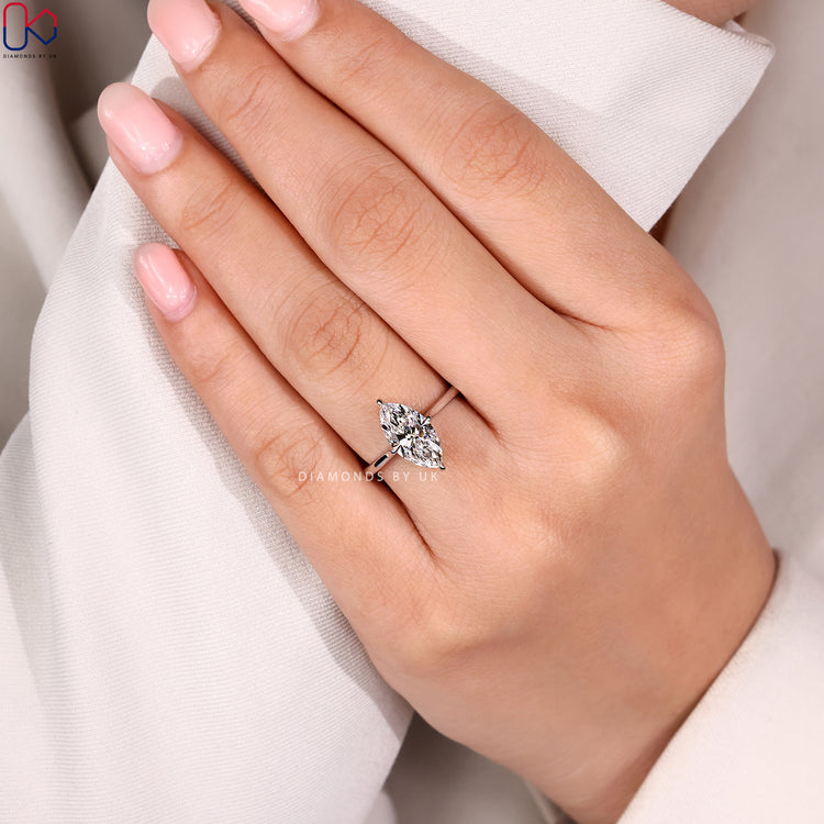 Marquise solitaire ring with cathedral style.