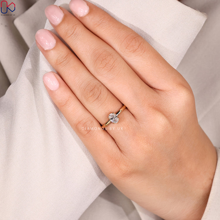 Oval solitaire ring with round diamond hidden halo.