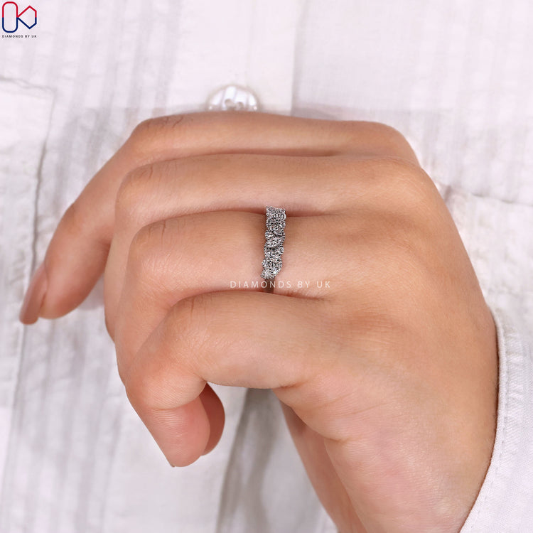 Round diamond half eternity band with marquise outline.