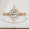 Marquise cut engagement ring with round side stone.
