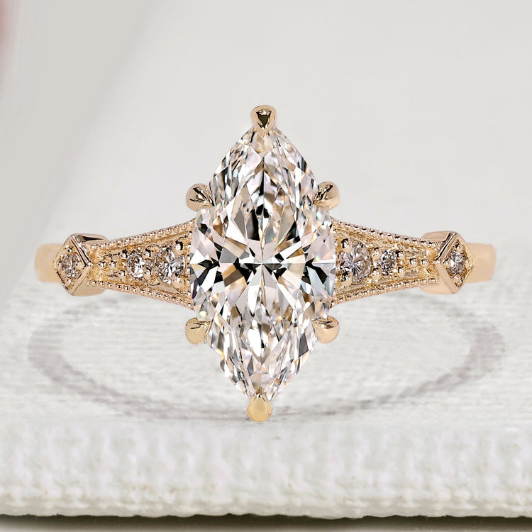 Marquise cut engagement ring with round side stone.
