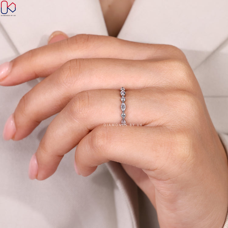 Marquise and round diamond band with bubble prongs.
