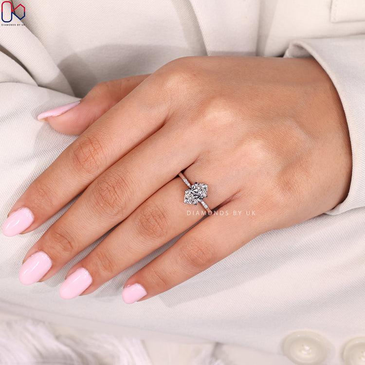 Oval cut ring with round diamond side accents.
