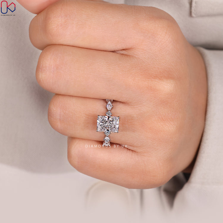 Shared prong radiant ring with pavé diamonds.