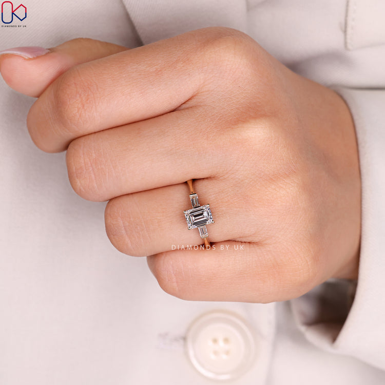 Three stone emerald cut ring with cathedral setting.