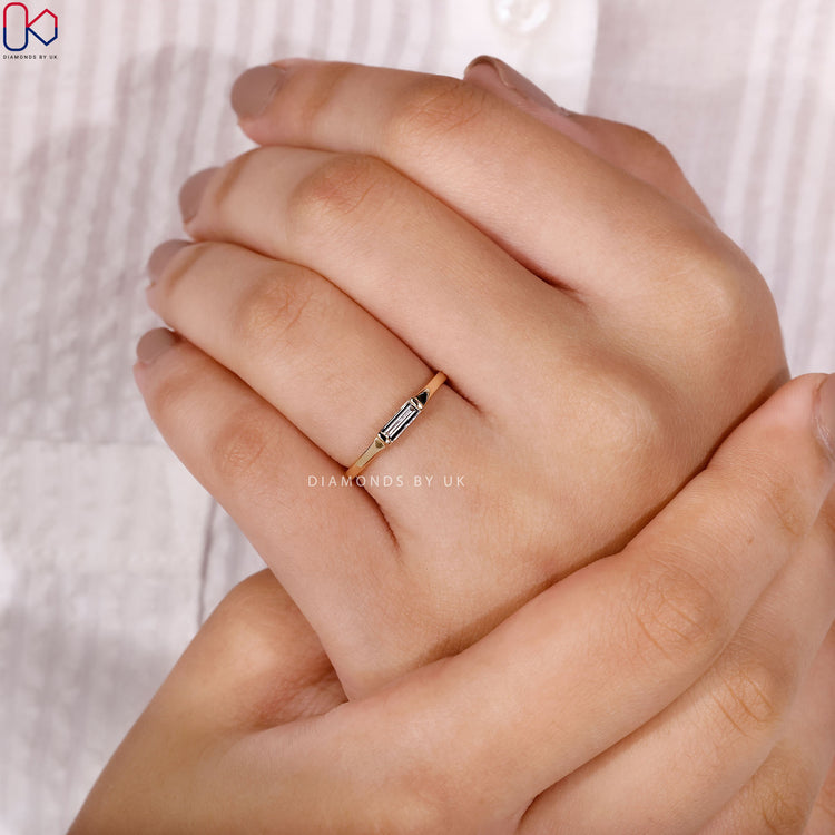 Baguette cut wedding band with simple solitaire design.