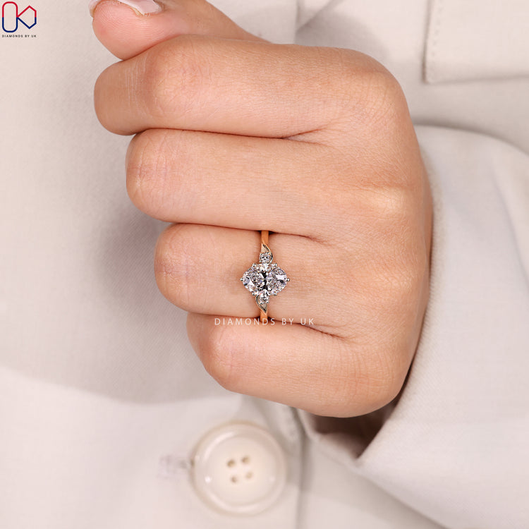 Six claw oval diamond ring with side stones.