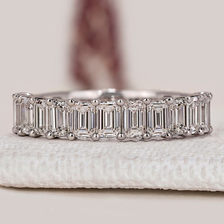 Emerald cut diamond band with half eternity style.