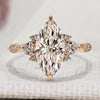 Marquise engagement ring with pear and round side stones.
